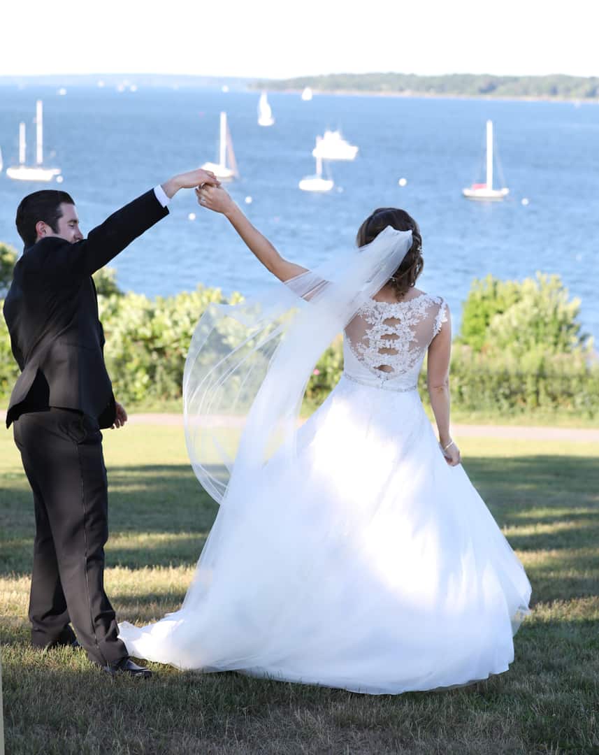 Bride and groom dancing near the ocean