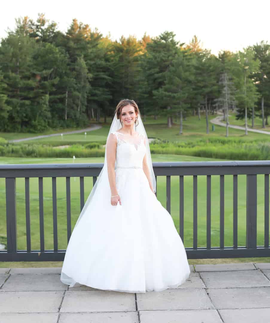 Bride on a balcony overlooking golf course