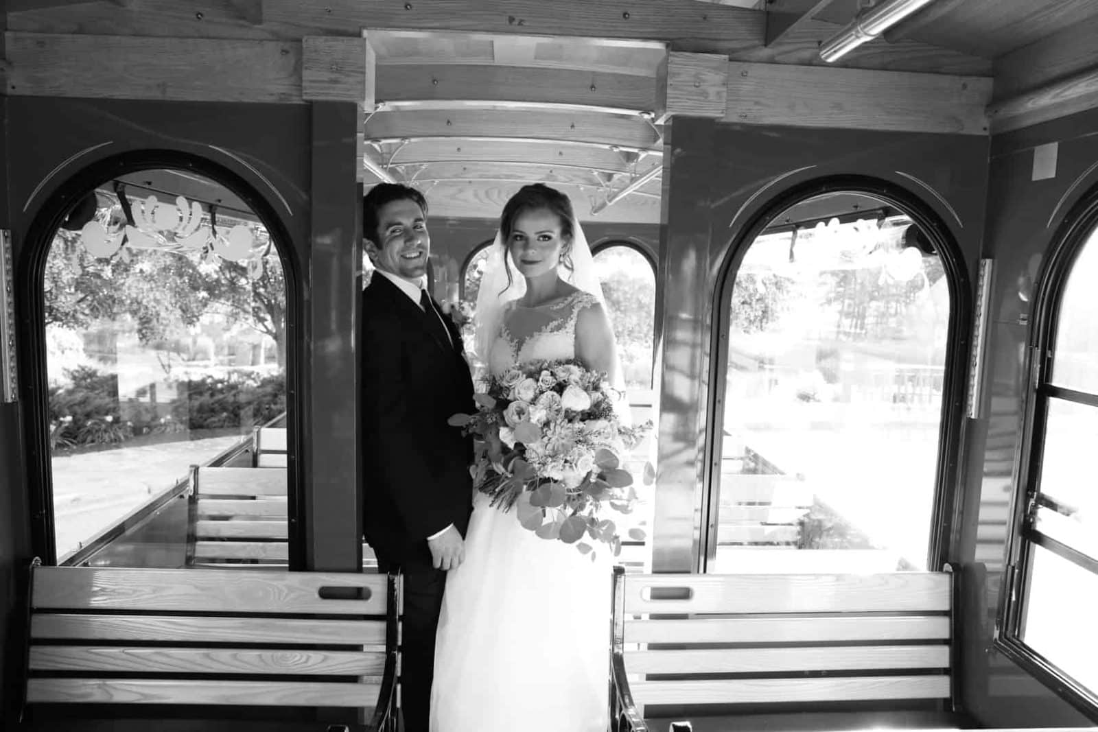 brideand groom on trolley embracing each other, black and white