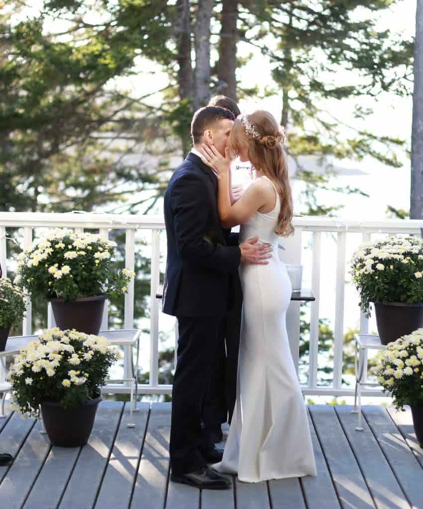 Bride and groom sharing the first kiss as husband and wife