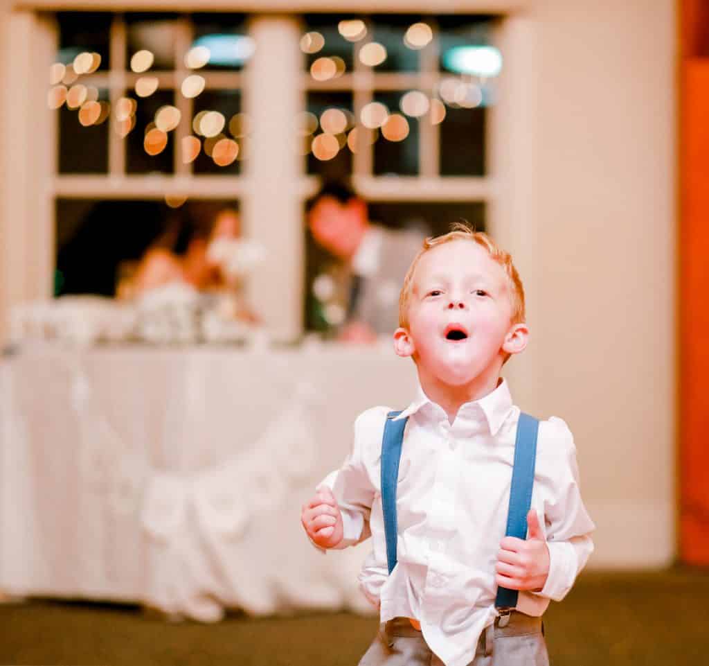 ring bearer excited for dancing looking at the camera