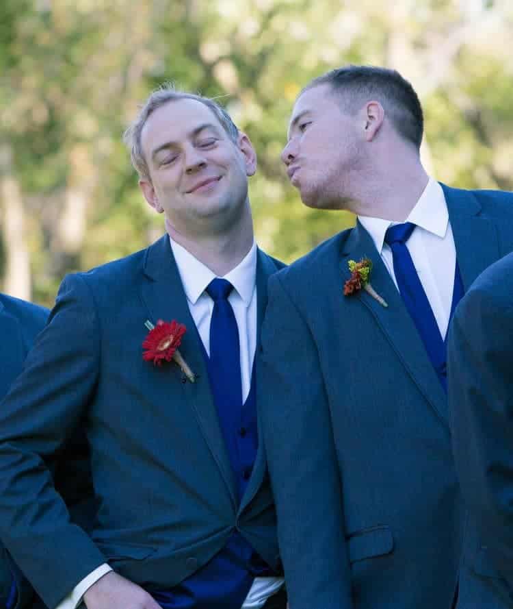 groomsmen kissing groom
