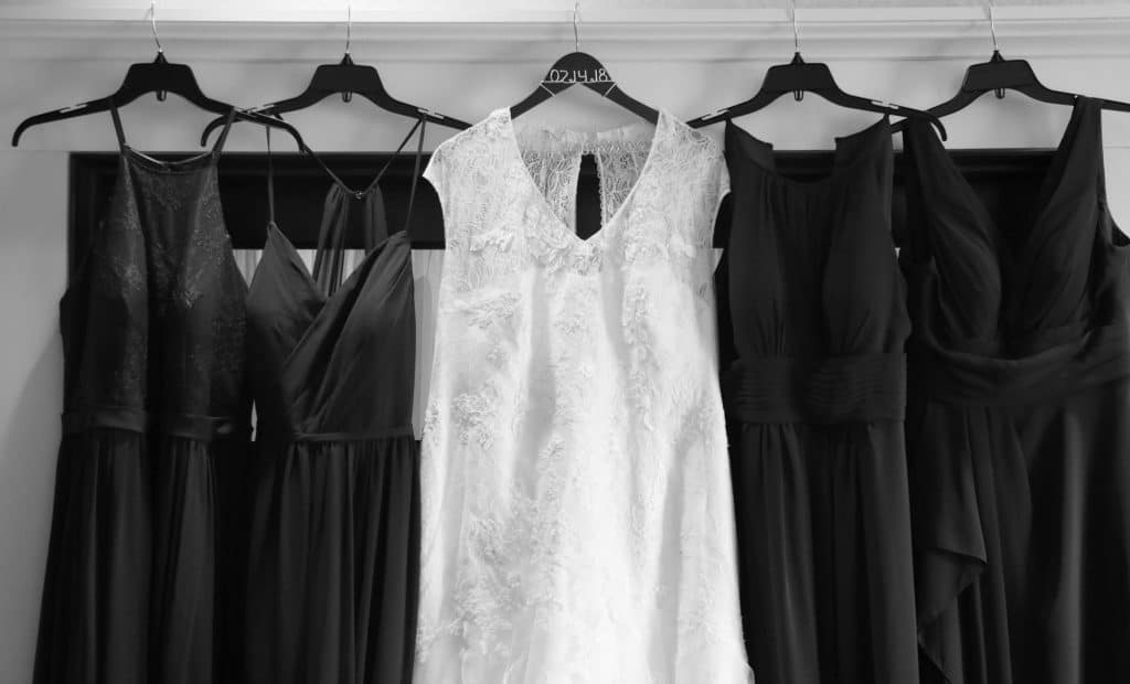 Wedding dress and bridsmaids dresses hanging together