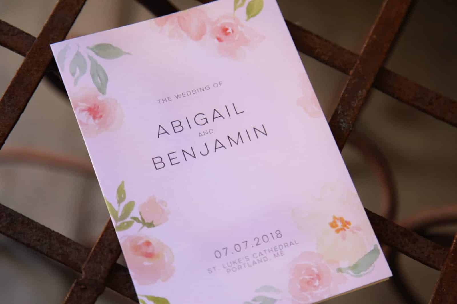 Wedding invitation on whicker table in church