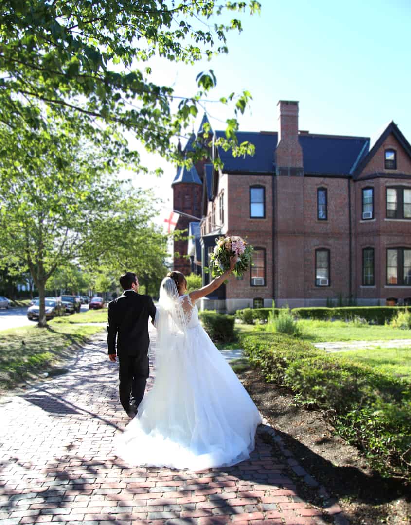 Bride and groom walking away from the church