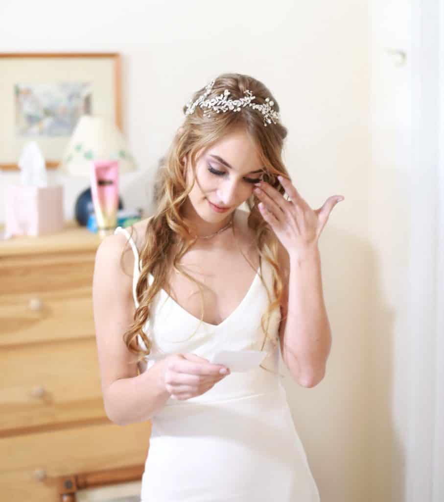 Bride getting reading her love letter from her husband to be 