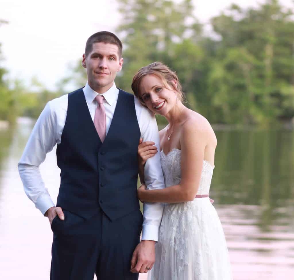 Bride and goom looking at the camera smiling