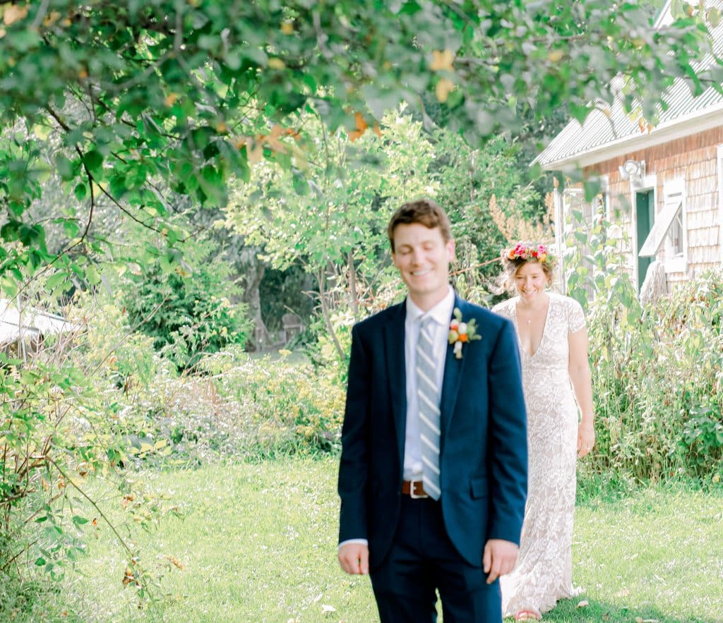 first look, groom look at the camera, bride behind her groom