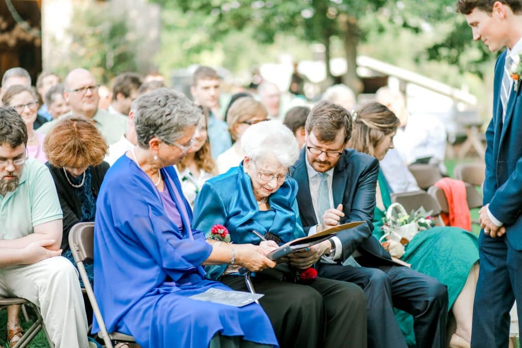 Mother of the bride and grandmother of the bride. Grandmother signing the marriage certificate.