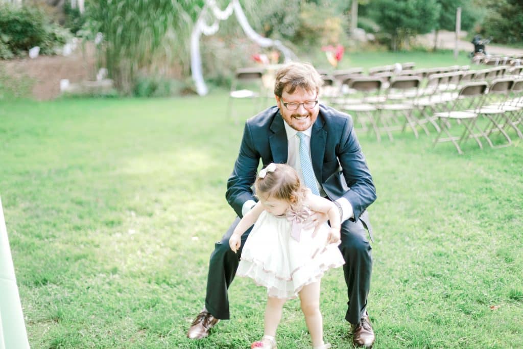 dad and daughter, kids swinging, and guests taking photos of each other