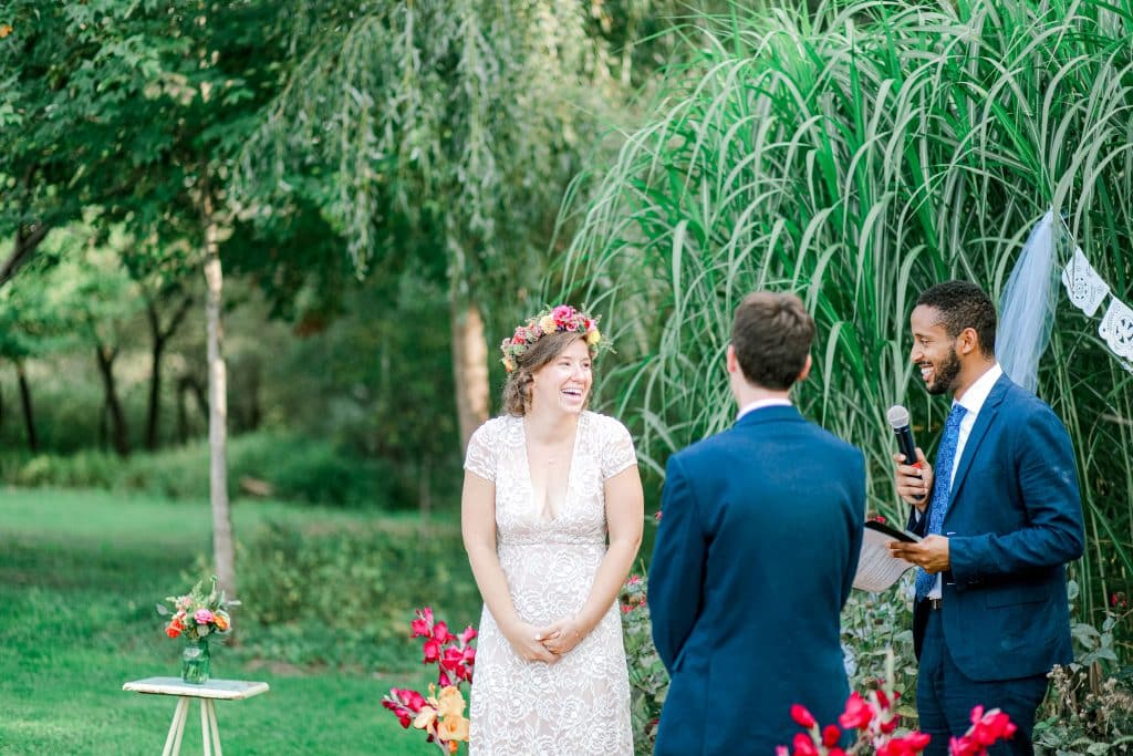 bride and groom at the outdoor alter bride laughing