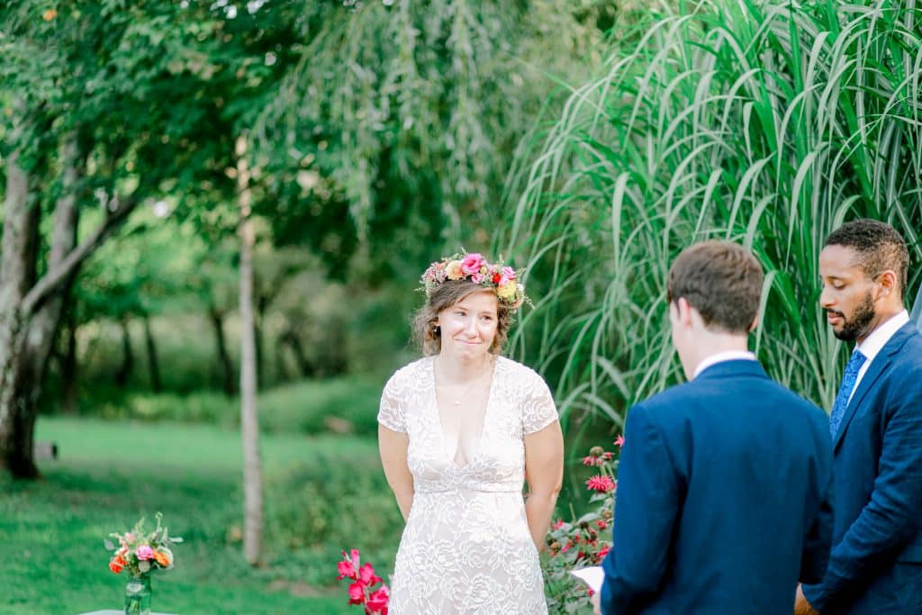 bride and groom at the alter, bride looking at her groom with love