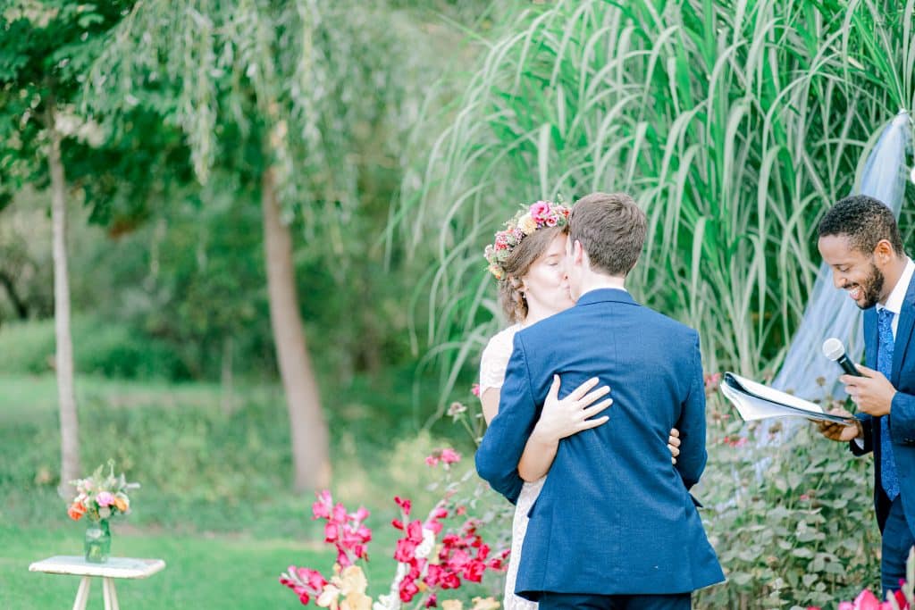 Bride and Groom kissing for the first time as husband and wife outside