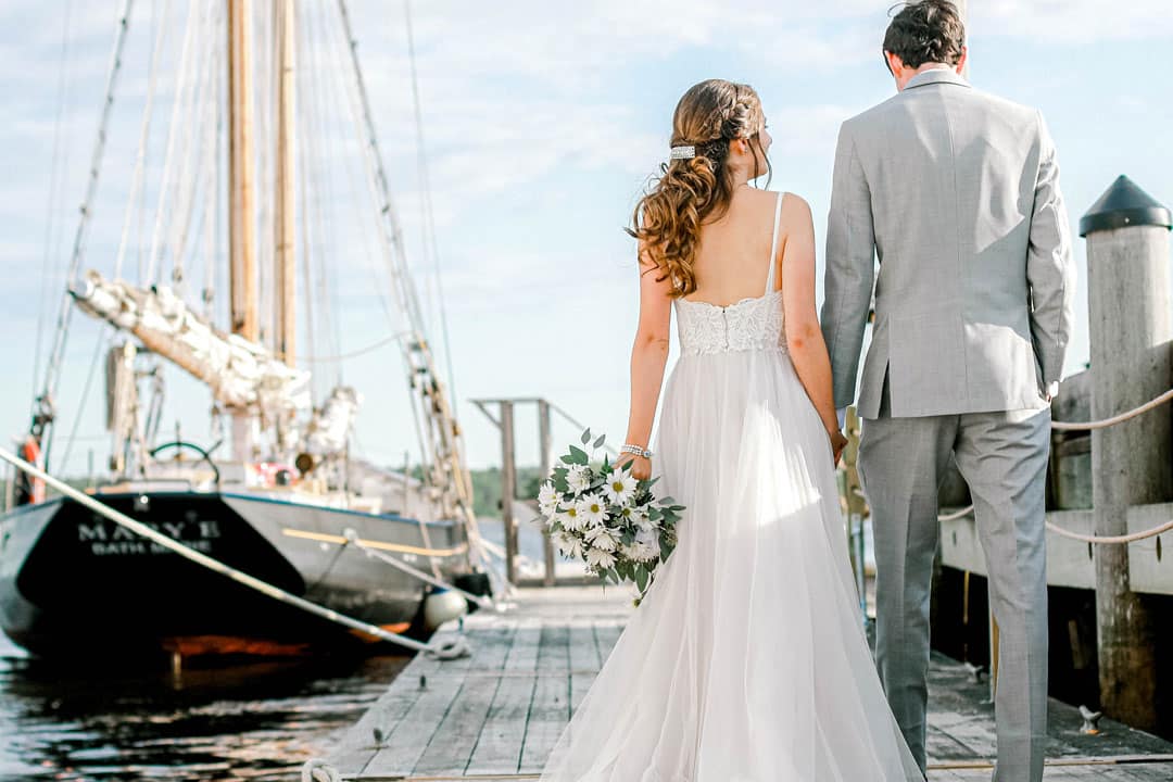 maine maritime museum wedding bride and groom next to sail boat