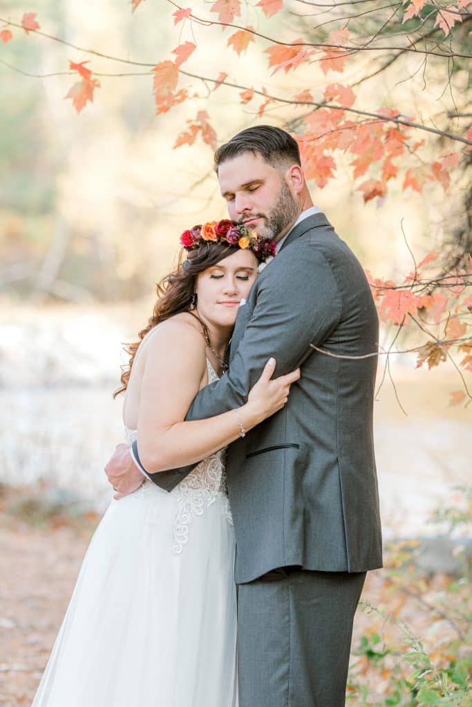 Bride and groom holding eachother in a backyard wedding