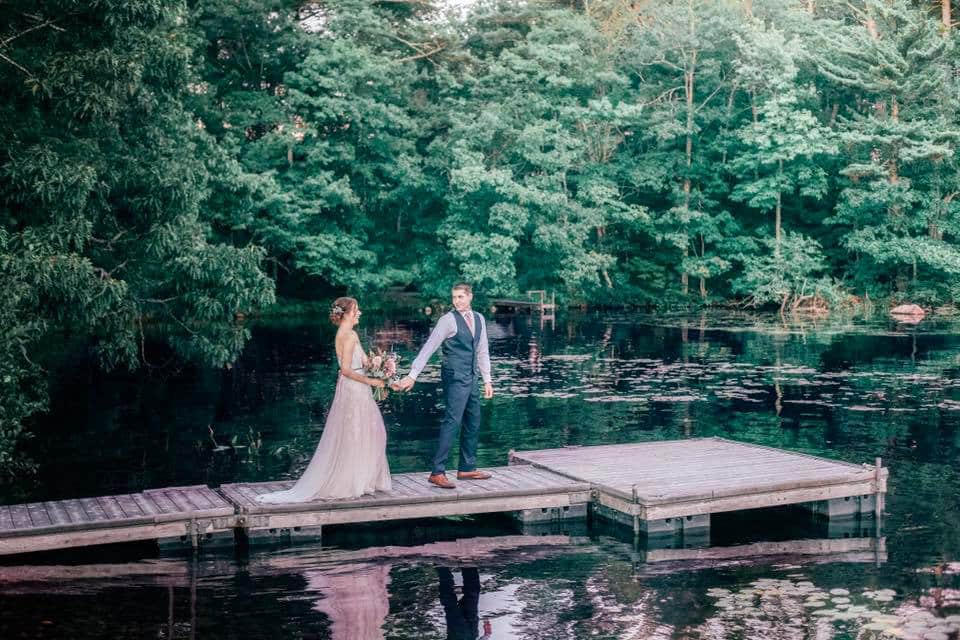 bride and groom on dock at maine lake wedding venue Alamoosook lakeside inn