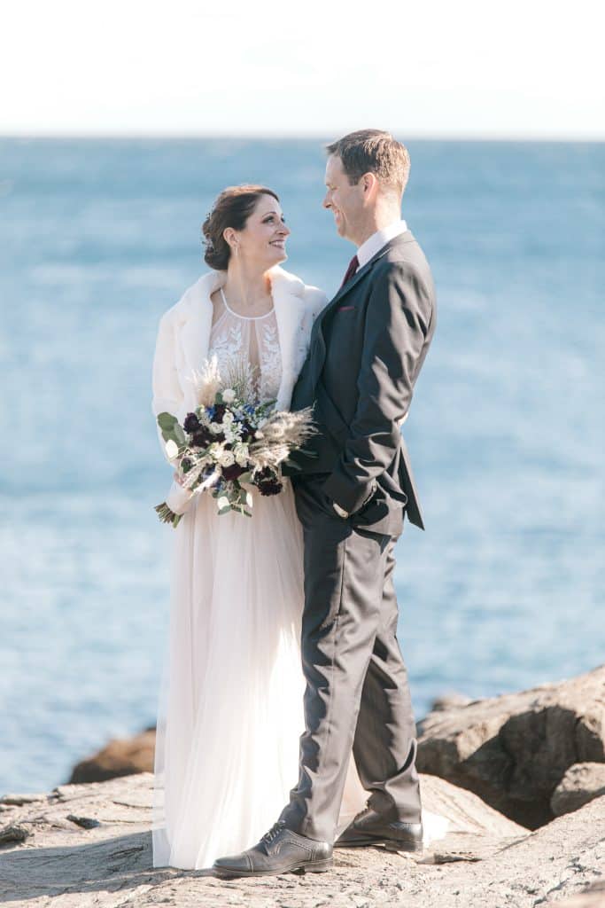 Bride and groom on the cliffs of Maine