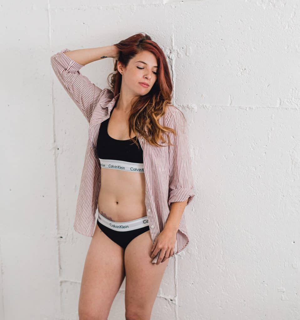 Boudoir model in studio with pink open t-shirt 