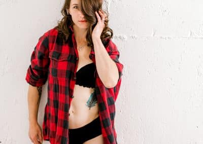 woman in red t-shirt in studio with black lace underwear