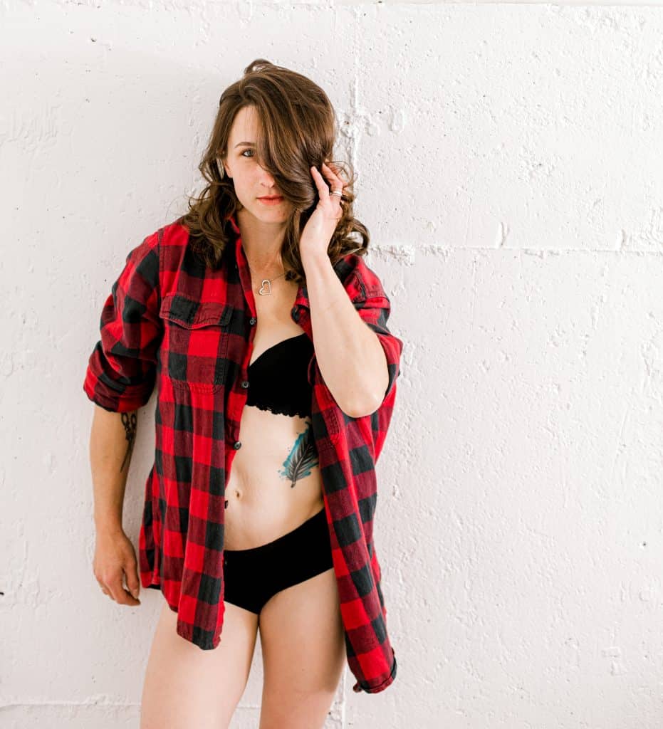 woman in red t-shirt in studio with black lace underwear