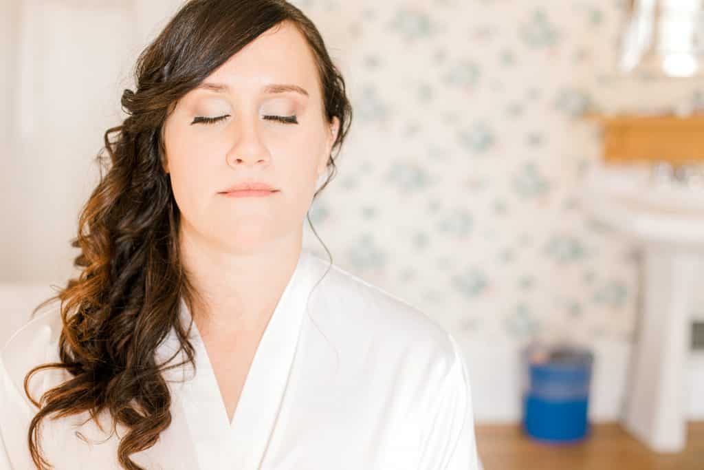 bride getting ready, makeup with eyes closed