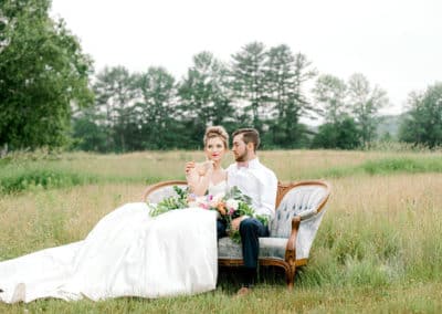 bride and groom on a couch for a photography session in maine