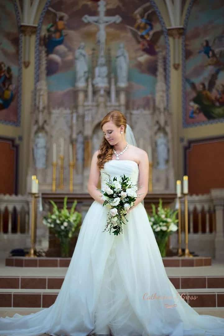 bride at alter in a church in Portland Maine