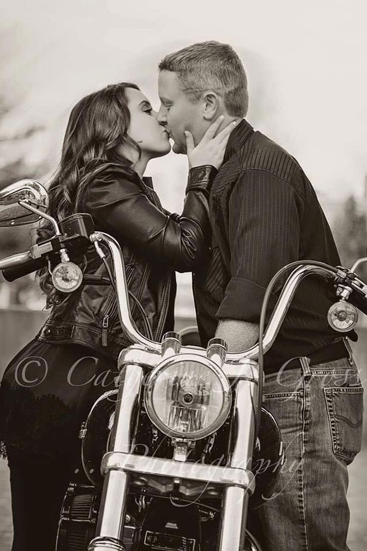 engaged-in-maine-motorcycle black and white engagement photo of engaged couple kissing on motorcycle in Maine