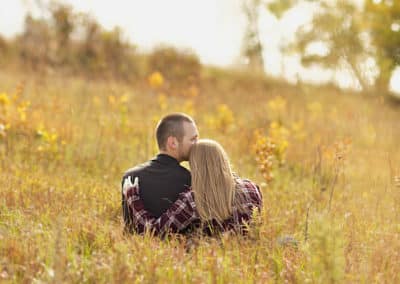 engaged maine couple in a field