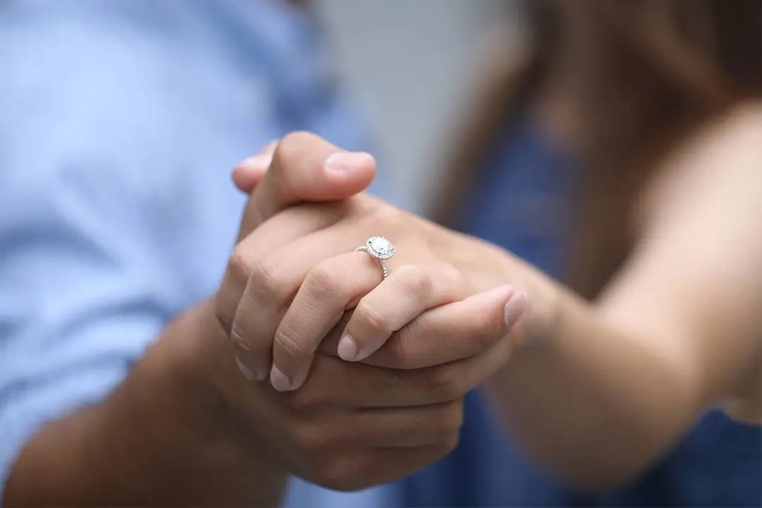 engagement ring holing hands