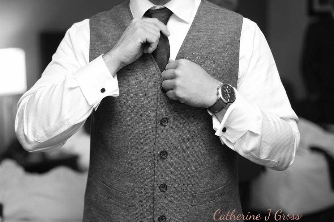 groom fixing tie