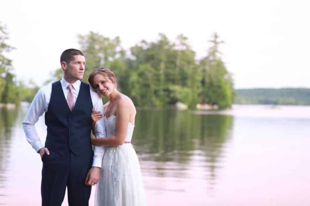 newlywed couple getting a wedding portrait on a maine lake