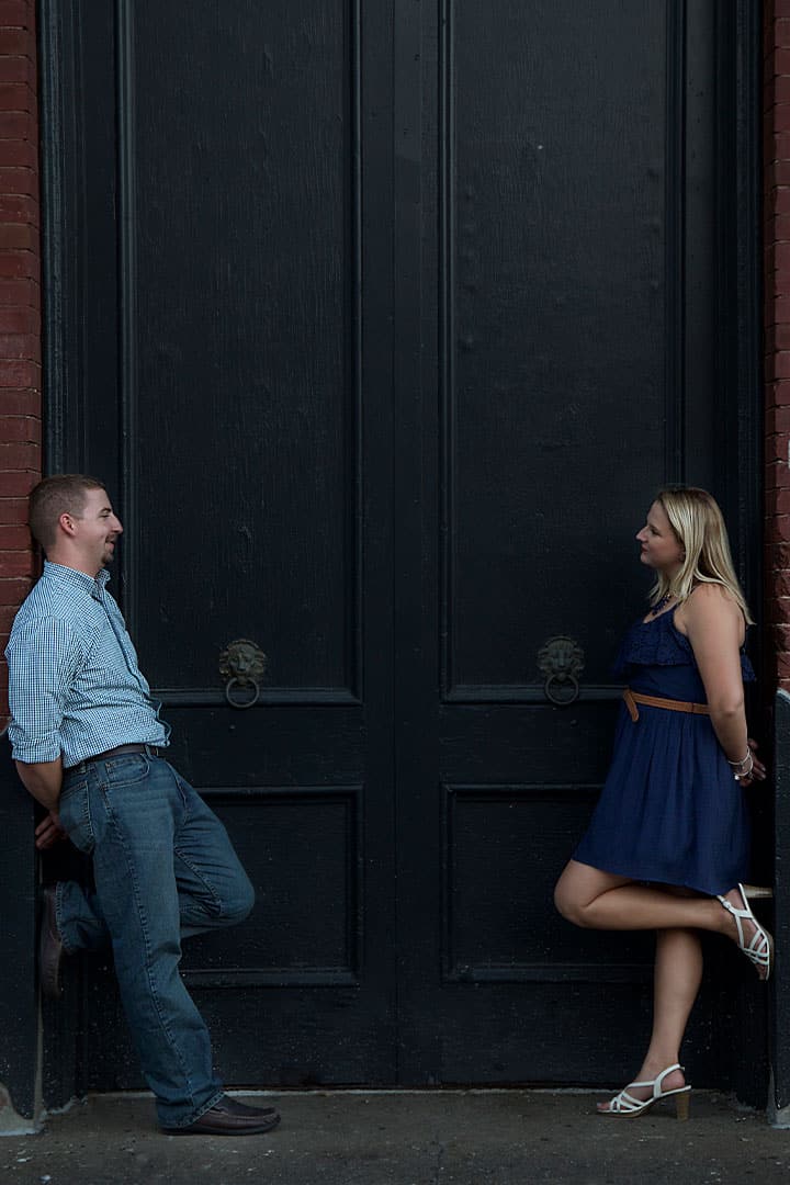 engagement photos in front of large door in maine