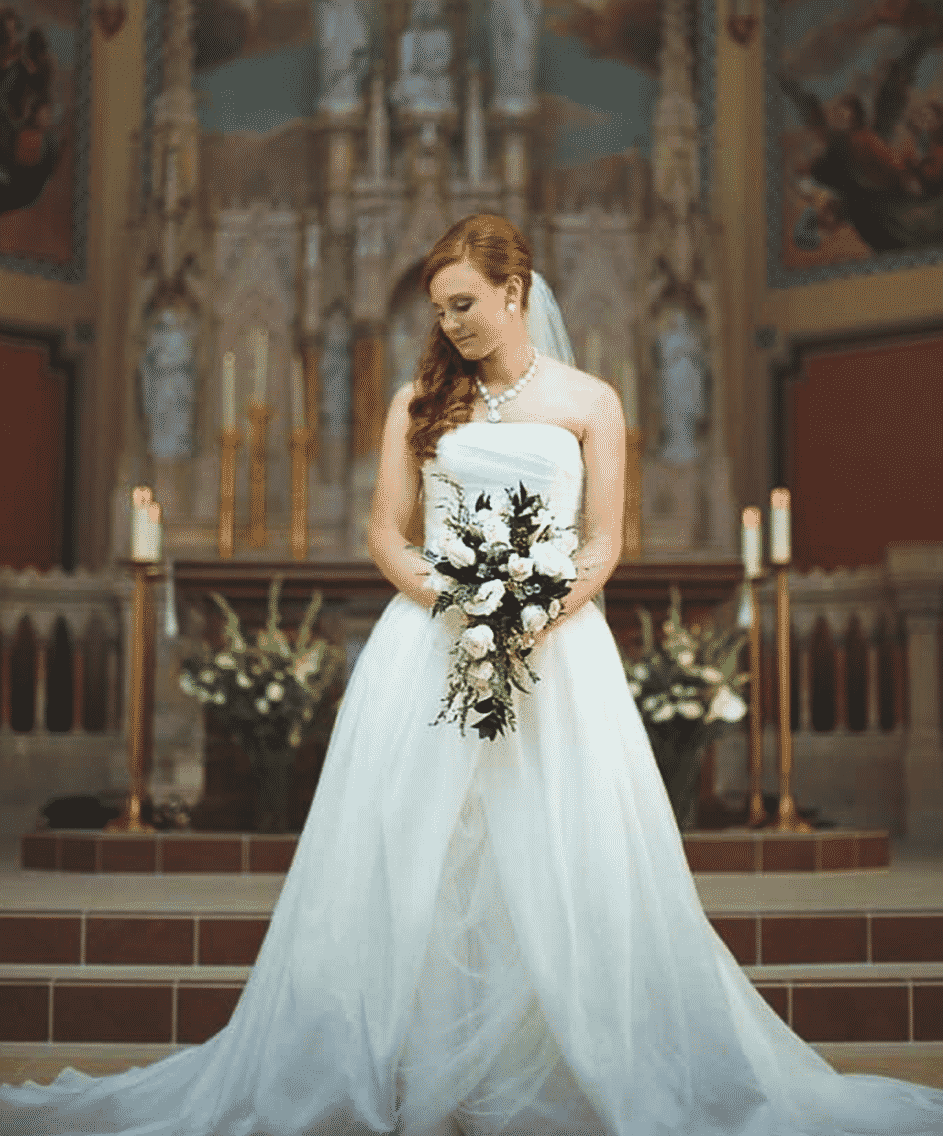 bride posing in cathedral in Bangor Maine