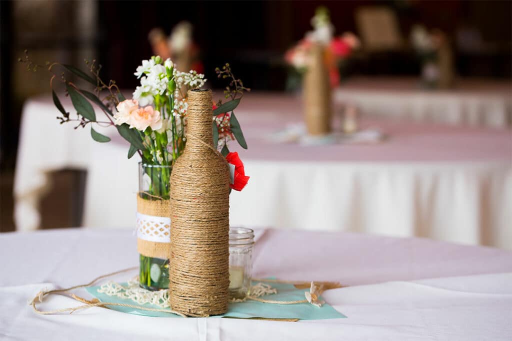 diy wedding centerpiece with bottles and flowers