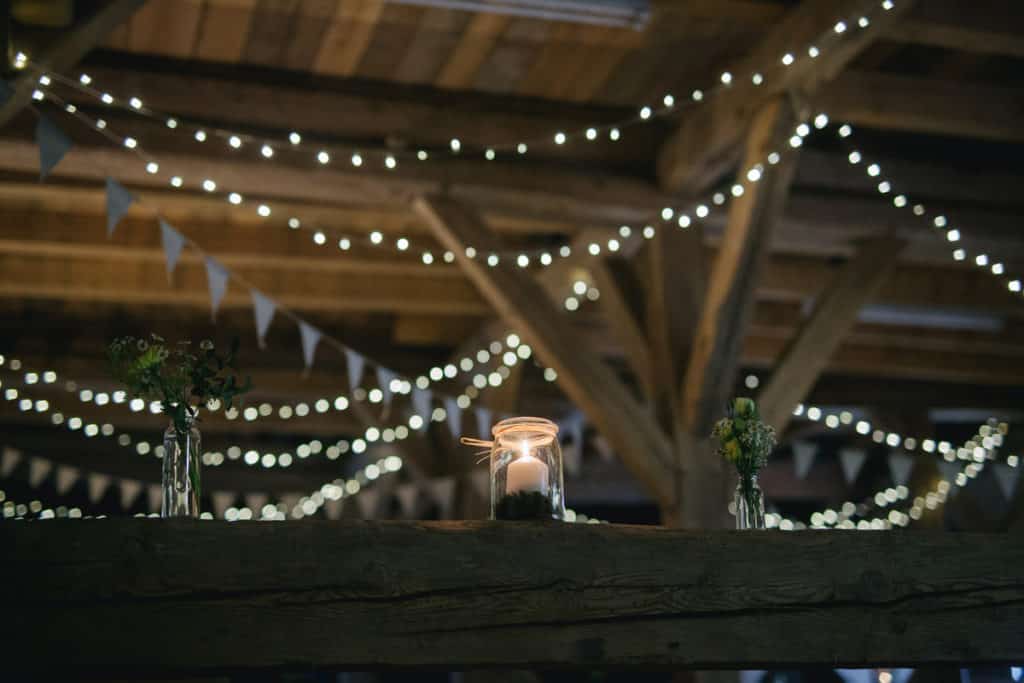 maine barn wedding venues decorated with candles and lighting