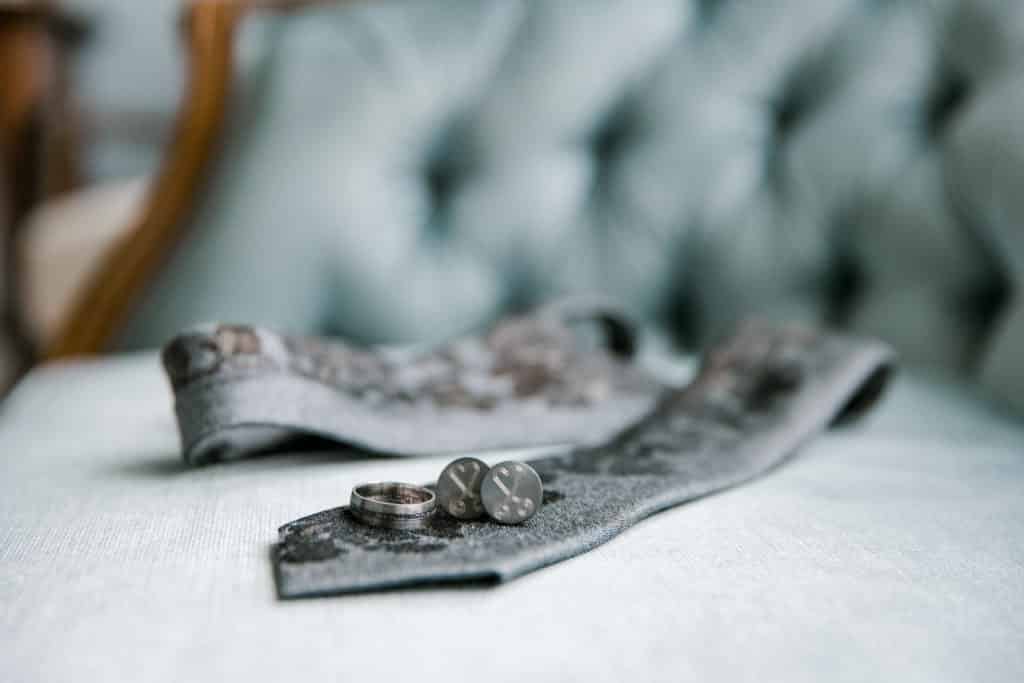 wedding details on blue chair, wedding tie, cuff links