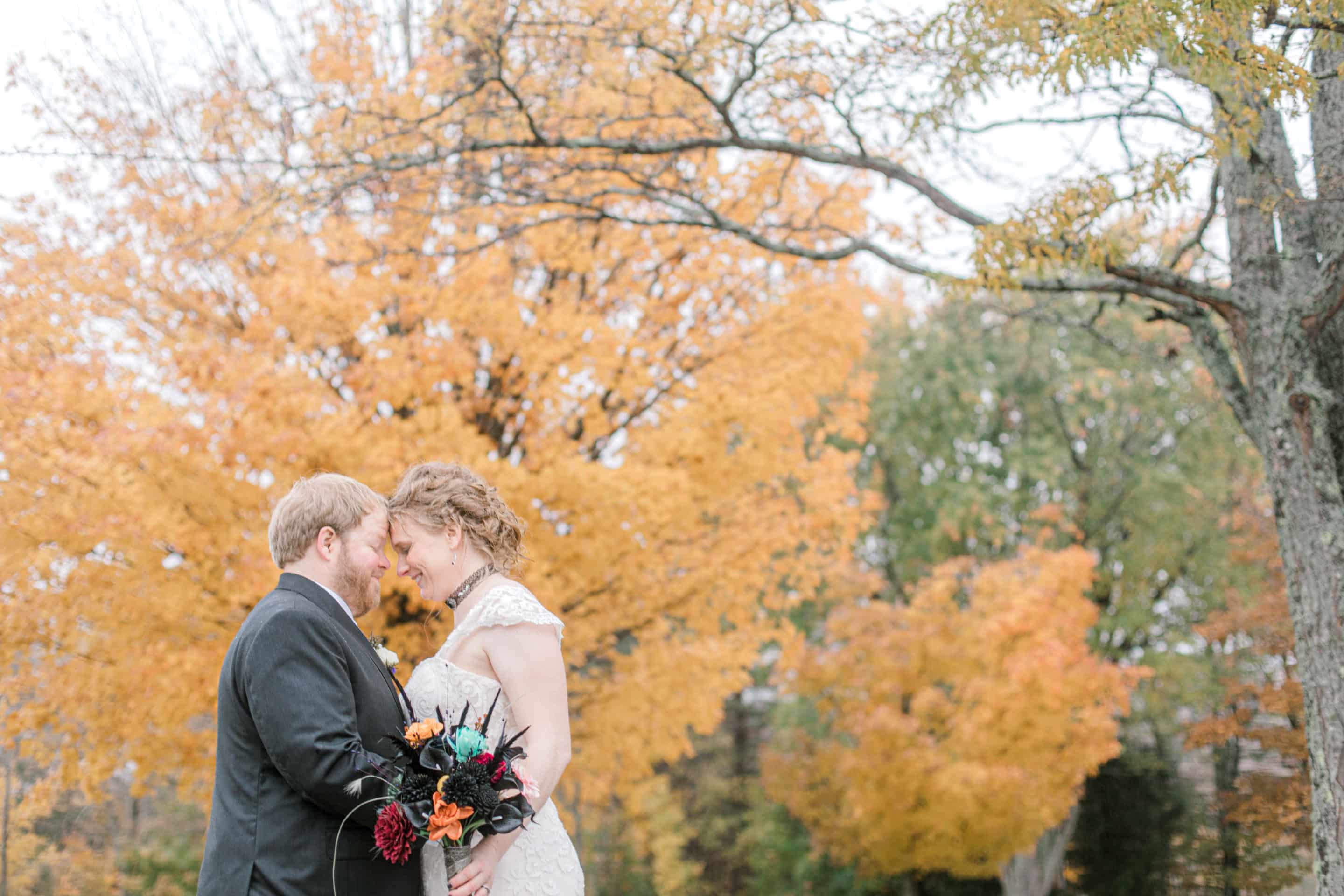 When to get married in Maine? Fall wedding photo with orange/yellow leaves