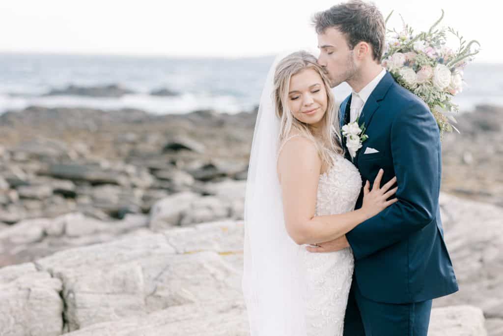 Newlyweds on the rocky beach of Peaks Island Maine