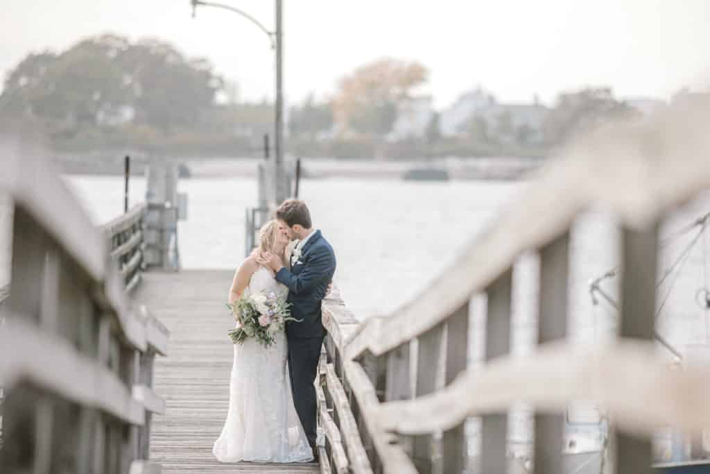 Peaks Island Dock Wedding bride and groom kissing