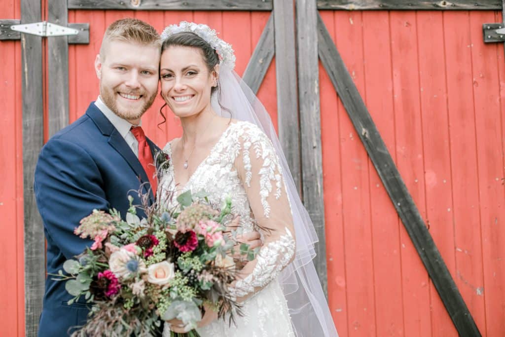 Coolidge Family Farm Wedding in front of red barn door