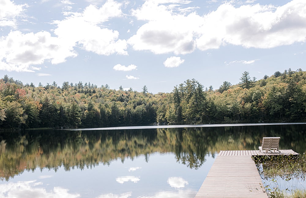 a dock going out onto a serene Maine lake