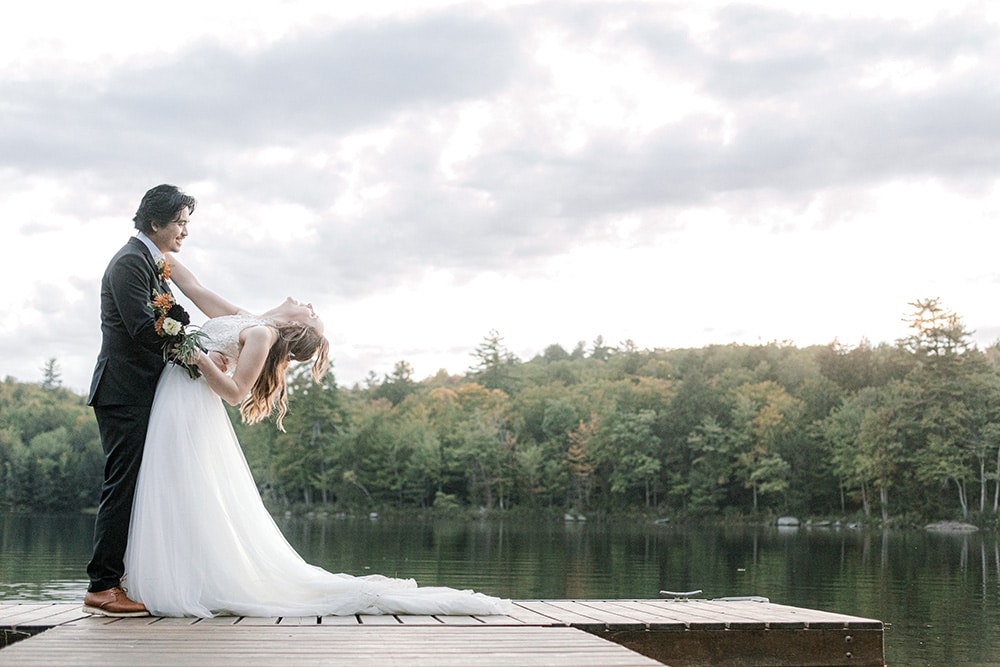 Maine lake wedding bride and groom on a dock on a private lake