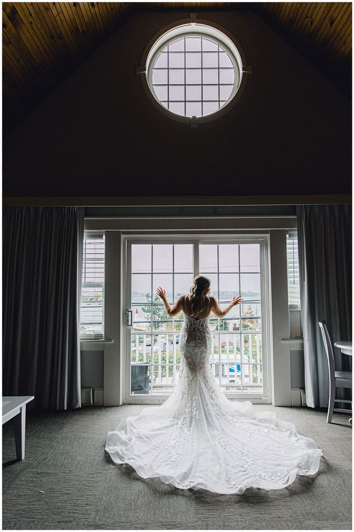 bride-opening-curtains-in-NH wedding photographer near Portsmouth new hampshire