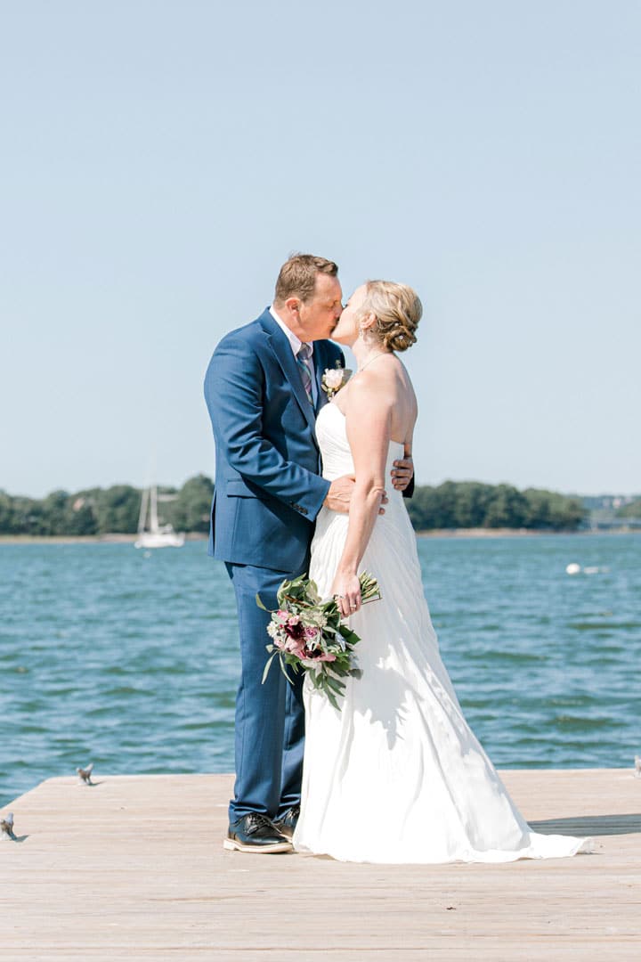 Maine engagement photo of couple holding a leaf