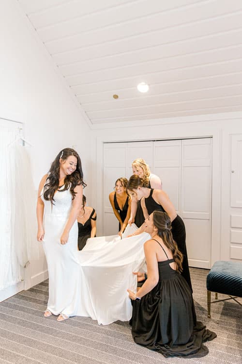 bride getting help with dress