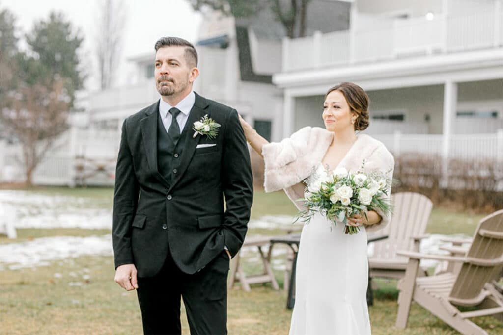 wedding first look with bride tapping groom on shoulder