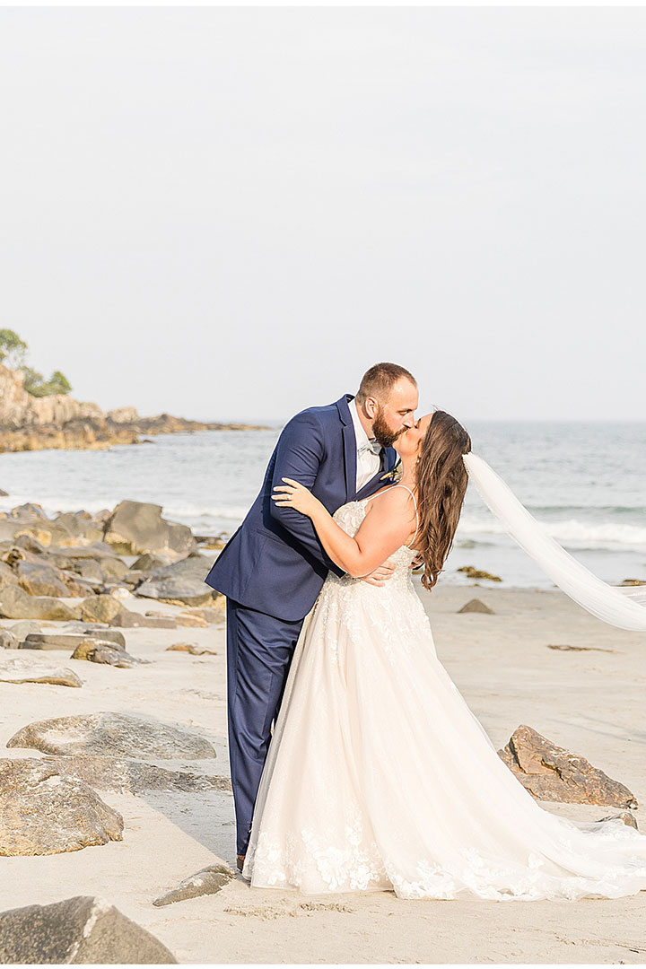 bride and groom kissing on a Maine beach