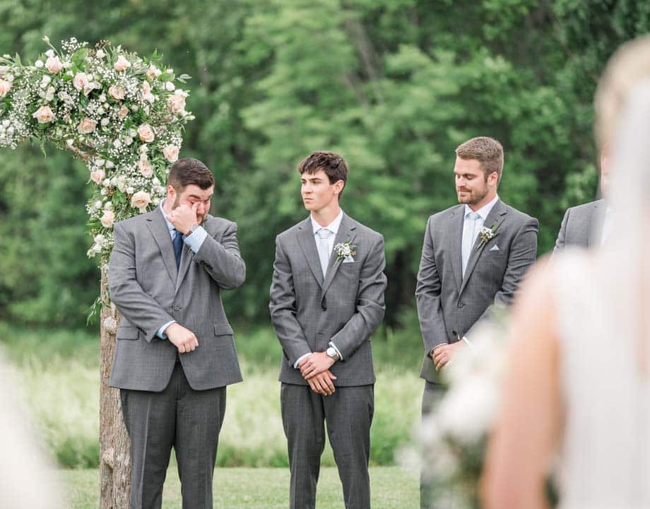 Groom tearing up as he sees his bride walking down the aisle