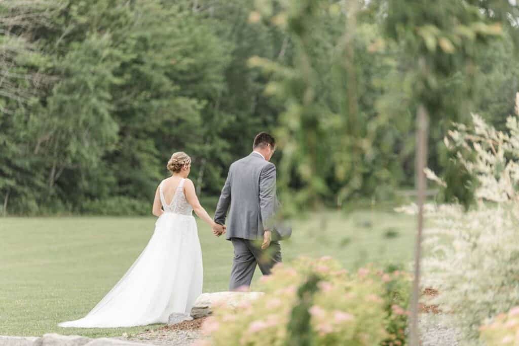 Bride and groom walking hand in hand at The Grove.